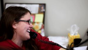 Superior Transport & Logistics female team member on phone smiling at her desk