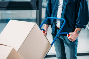 Man pushing a dolly filled with boxes