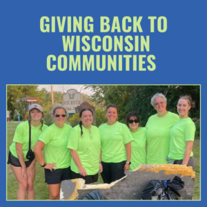 Picture of Superior team members wearing green shirts and smiling outside near park after community clean up day in Wisconsin